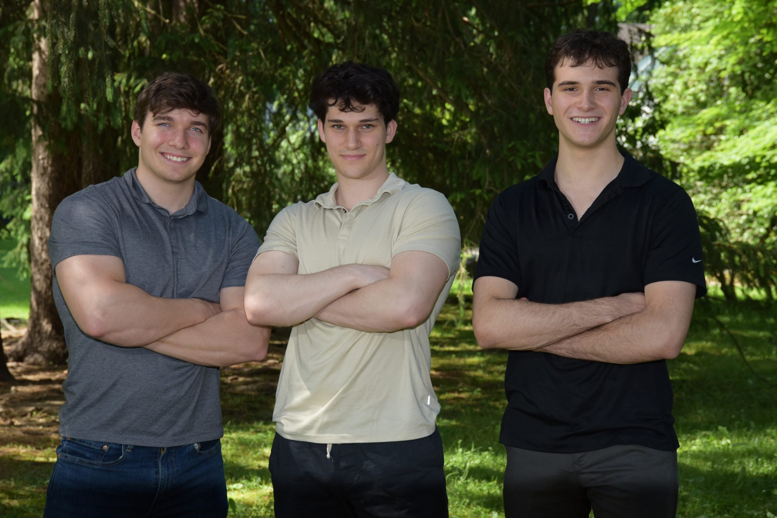 Photo of John Andrzejewski, Eli Kerstein, and Lucas Raskin standing together with their arms crossed.